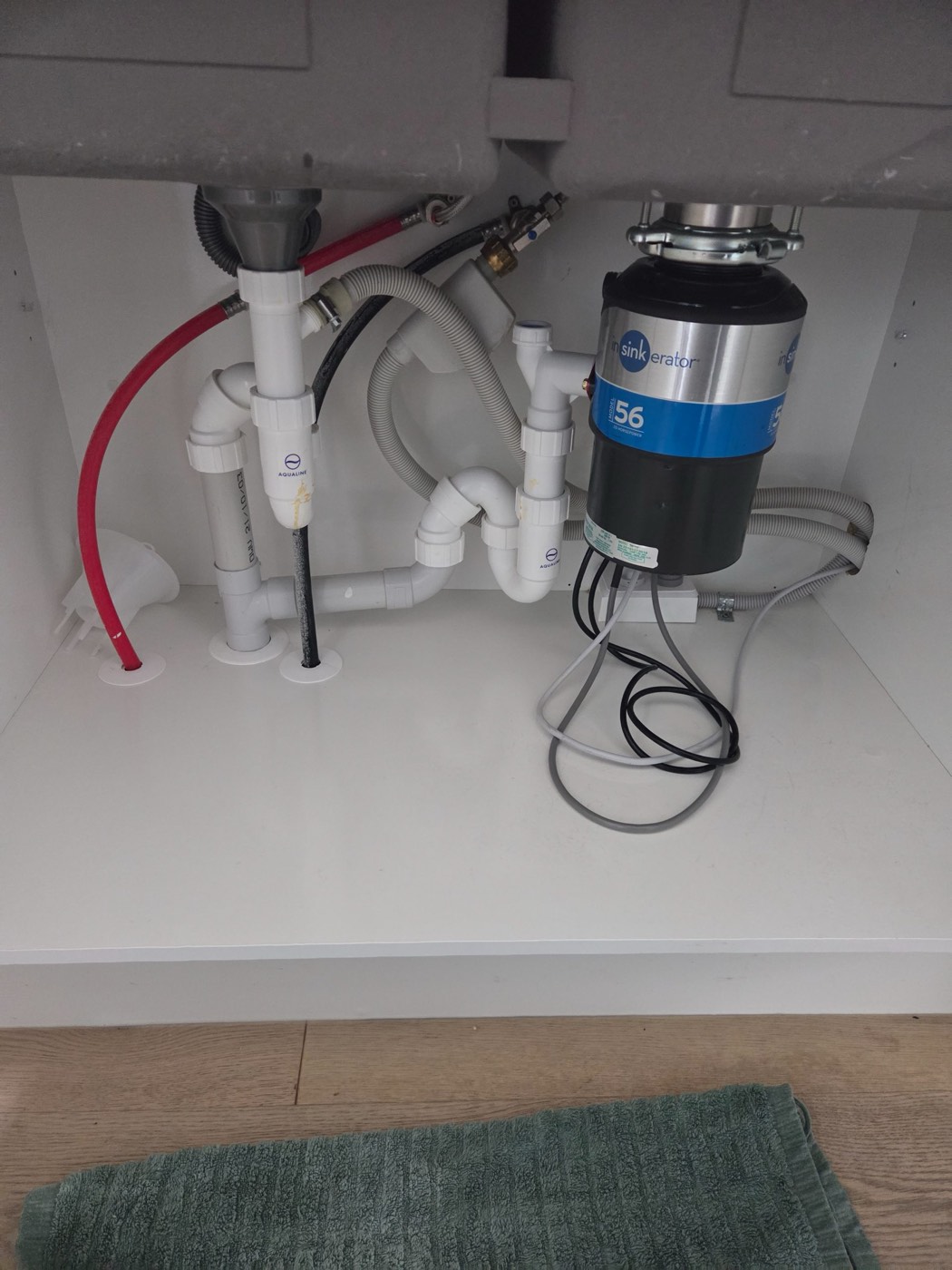 Castor Bay: water under the sink in a nearly-new kitchen