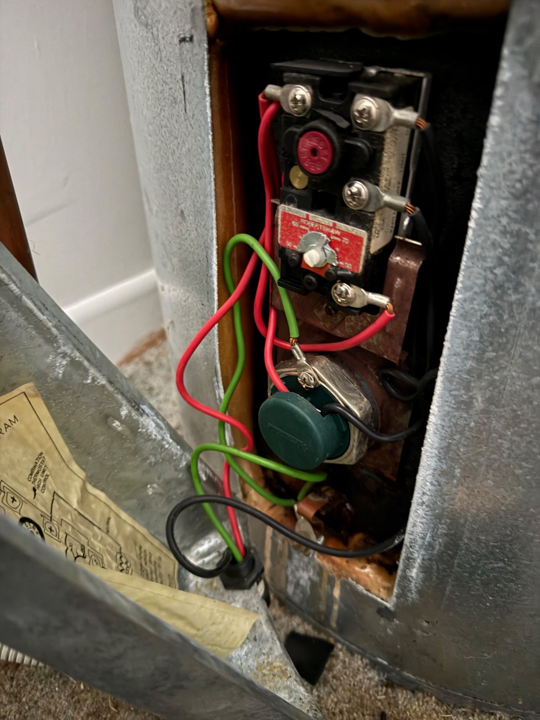 Wiring beside a hot water cylinder, wet from a leaking tank