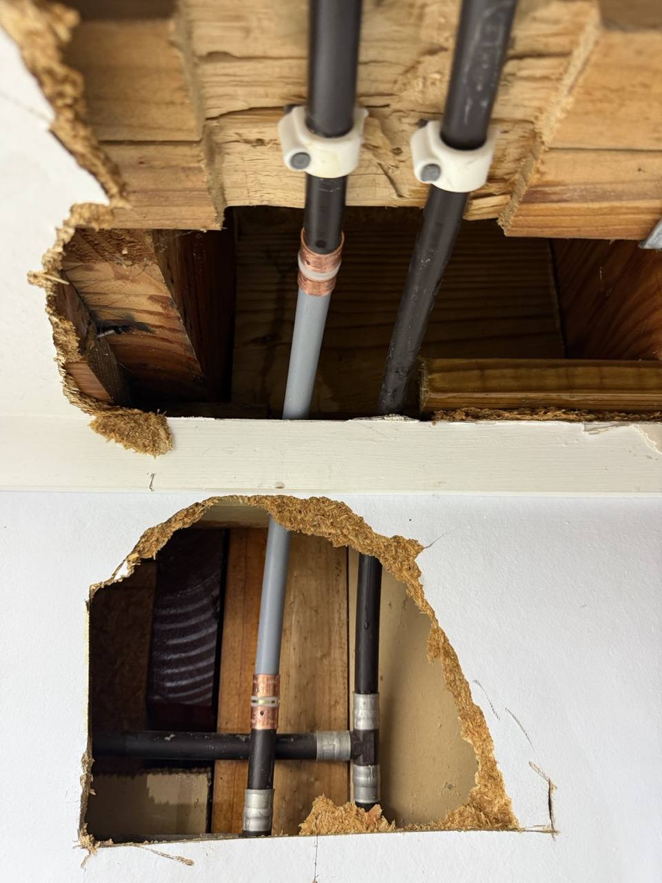 Repaired Dux Quest in a West Harbour ceiling, with a new lighter grey pipe section joined to the old dark pipe using copper crimp joiners