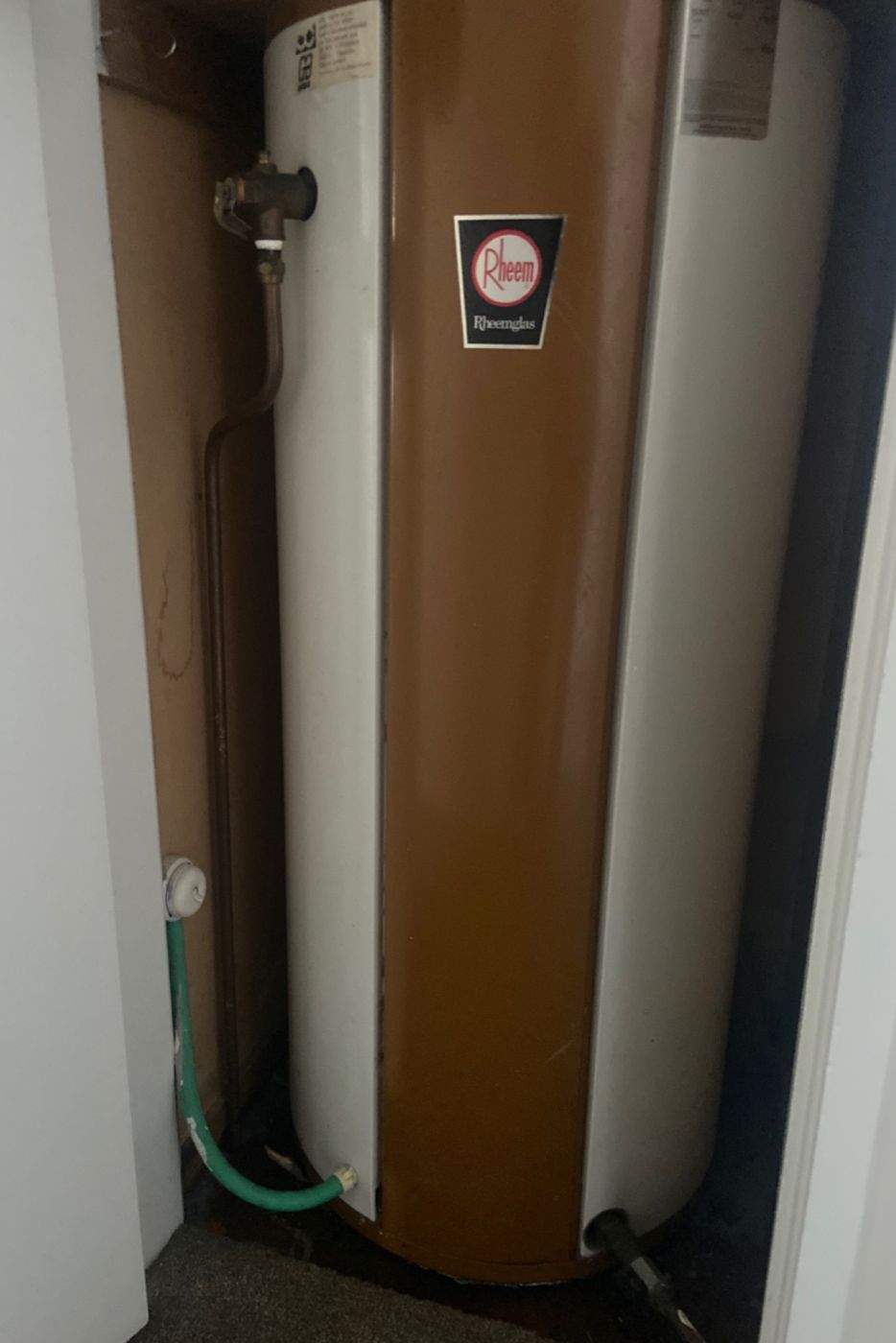 An older hot water cylinder in an Auckland home, due for replacement