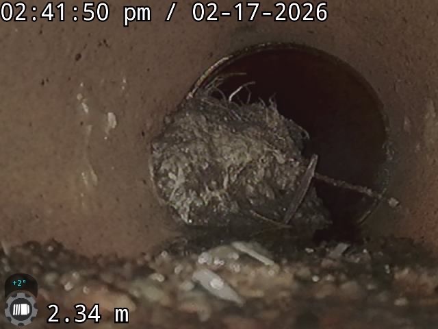 CCTV view of a ball of tree roots blocking a drain pipe at a joint