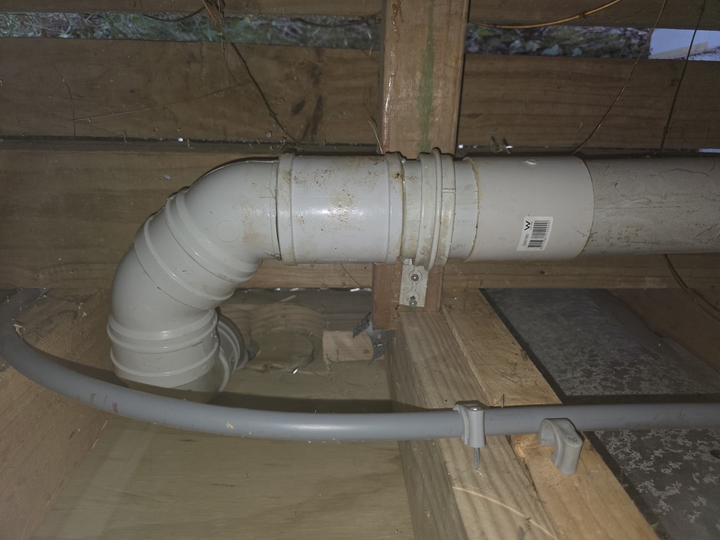 Under the floor: the toilet waste dropping through the floor and turning into the main drain, which is what an S trap looks like from below